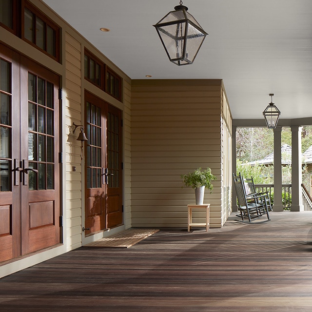 A spacious closed-in porch features a beautiful Woodluxe® stained floor.