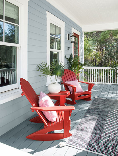 Front porch with wooden chairs painted in Caliente AF-290.