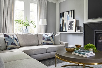 A neutral room with gray walls and a gray couch