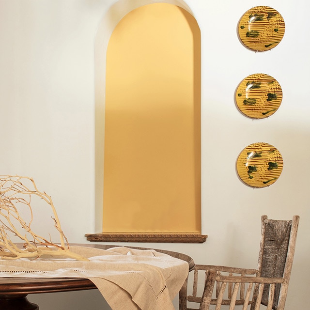 Élégante salle à manger aux murs d’accent jaunes.