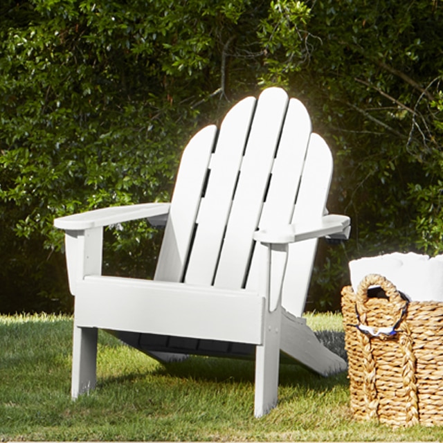 Wood Adirondack chairs painted in a white paint color.
