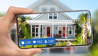 Phone taking a picture of a home exterior for social media.