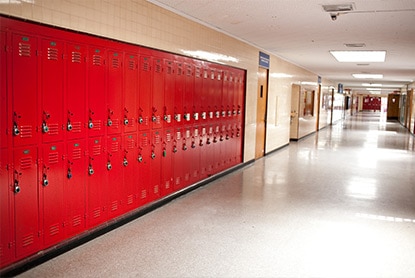 A bank of red, impact-resistant lockers offer both longevity and aesthetic appeal when sealed with high durability enamel coating.