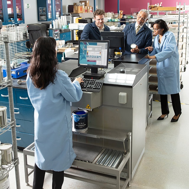 Several Benjamin Moore lab techs work on computers in the R&D lab.