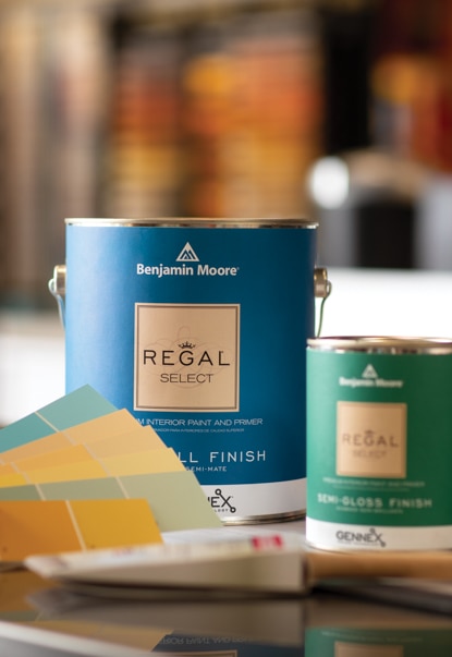 A person evaluates Benjamin Moore display chips near a can of Regal® Select Interior paint.