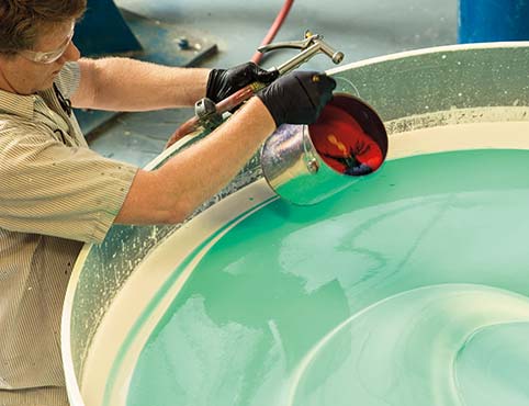 A Benjamin Moore employee mixes a vat of paint. A Benjamin Moore employee mixes a vat of paint.