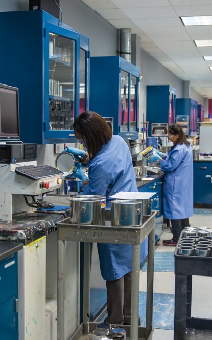 Chemists work on Benjamin Moore's premium paint. Chemists work on Benjamin Moore's premium paint.
