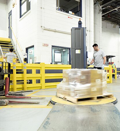 Two Benjamin Moore employees working in a warehouse.