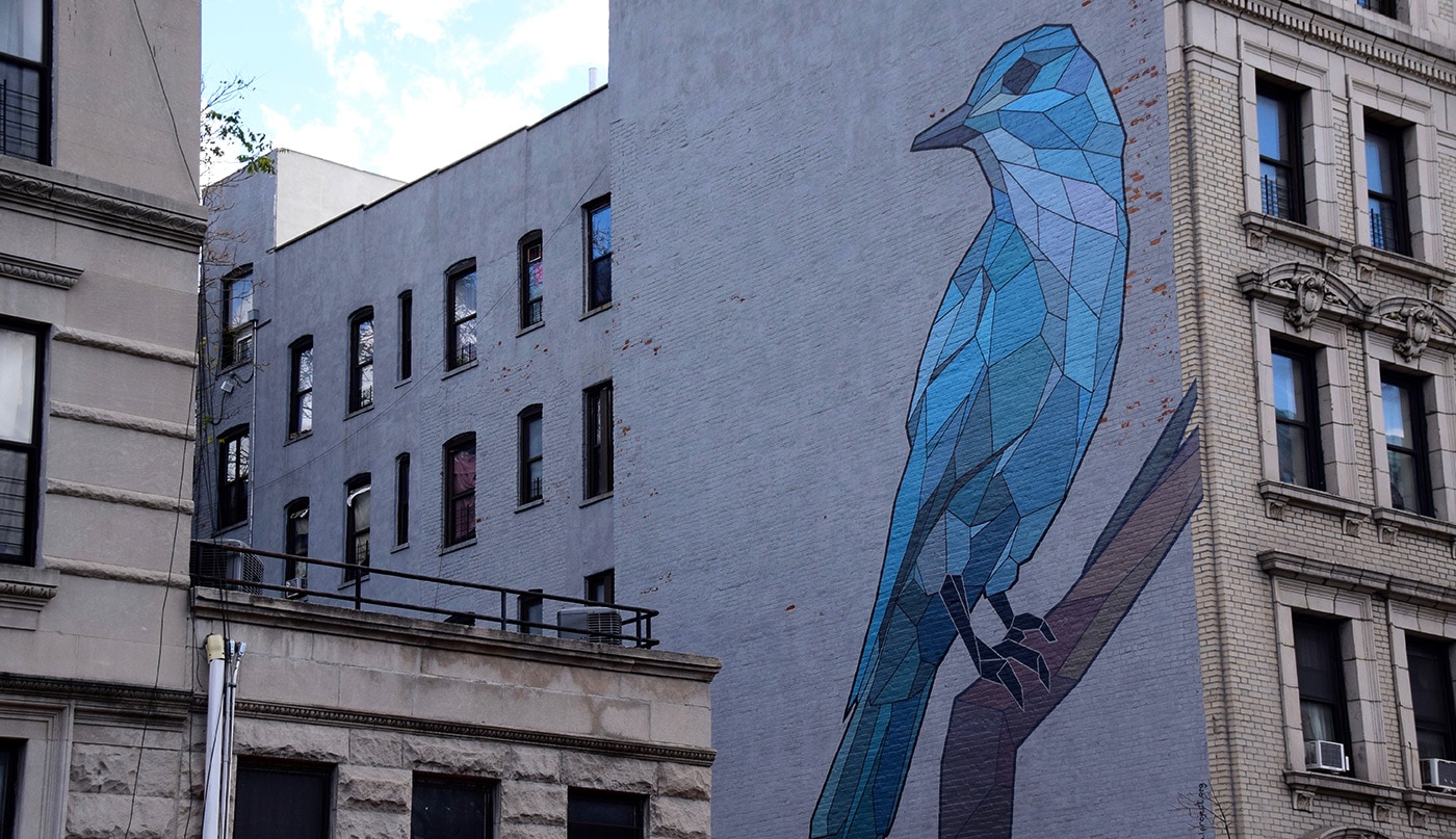 A blue bird on a city wall in Harlem as part of the Mary Lacy Mural Tour.