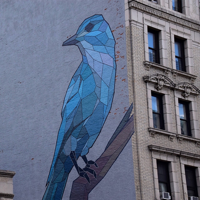 A blue bird on a city wall in Harlem as part of the Mary Lacy Mural Tour.