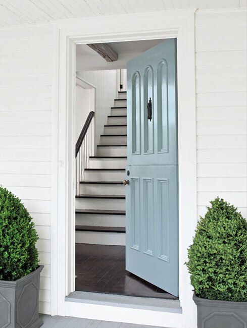 Attractive and inviting light blue front door