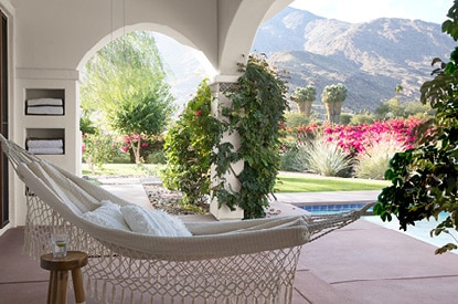 Scenic pool deck with Evening White OC-81 walls overlooking a mountain range.