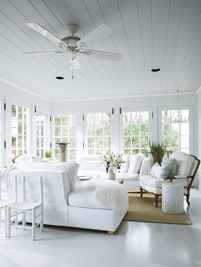 Pristine white sunroom painted in Cascade White 2127-70 with matching white furniture.