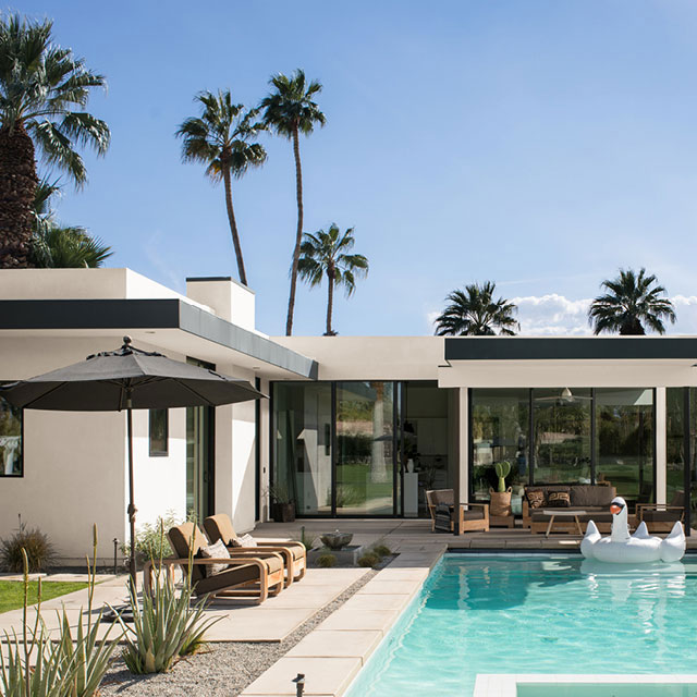 Beautiful backyard pool area with house siding painted in Swiss Coffee OC-45.