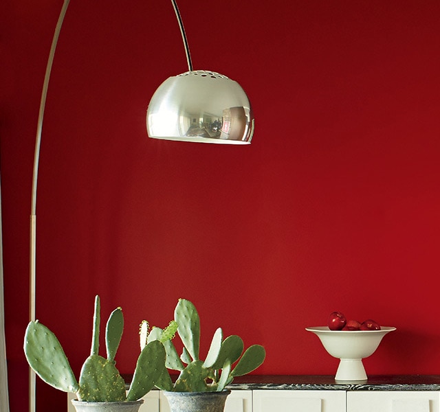 A contemporary dining room with a red accent wall.