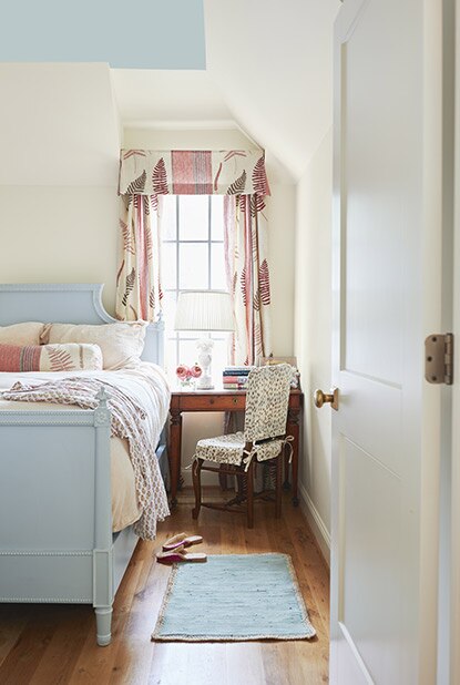 Cozy bedroom with bay windows and panelled walls