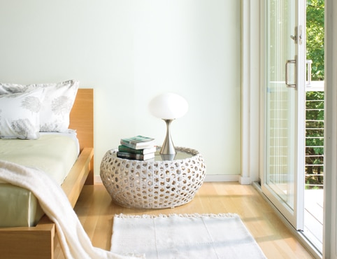 Cozy bedroom with bay windows and paneled walls