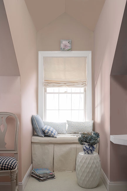 First Light pink paint color by Benjamin Moore in a cozy room with window seat. Come see the Best Sophisticated, Chic and Subtle Pink Paint Colors! #firstlight #benjaminmoore #paintcolors #interiordesign #pinkpaint