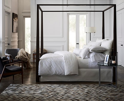 A serene bedroom features Benjamin Moore paint and Gluckstein Home bedding. A serene bedroom features Benjamin Moore paint and Gluckstein Home bedding.