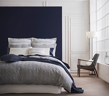 A serene bedroom features Benjamin Moore paint and Gluckstein Home bedding. A serene bedroom features Benjamin Moore paint and Gluckstein Home bedding.