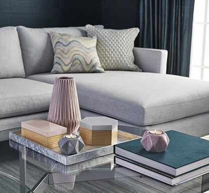 A welcoming sectional couch with pillows and a glass-topped coffee table make an elegant seating area in a bedroom corner. A welcoming sectional couch with pillows and a glass-topped coffee table make an elegant seating area in a bedroom corner.