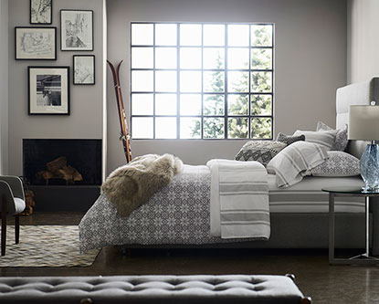 A serene bedroom features Benjamin Moore paint and Gluckstein Home bedding. A serene bedroom features Benjamin Moore paint and Gluckstein Home bedding.