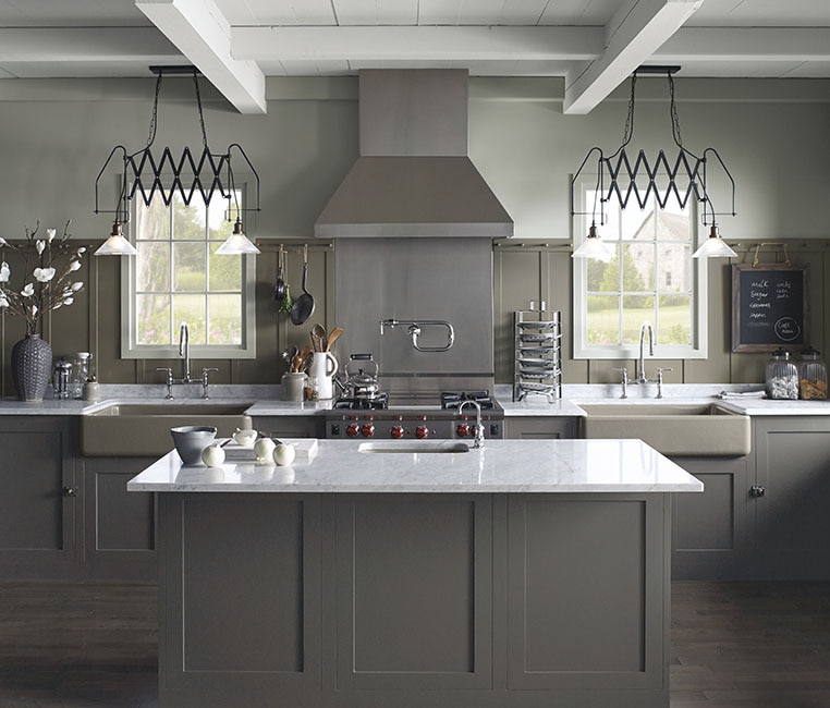 Gourmet, grey kitchen with marble centre island and farm sink with Kohler hardware