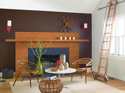 Living room with wide fireplace, purple wall and rolling ladder