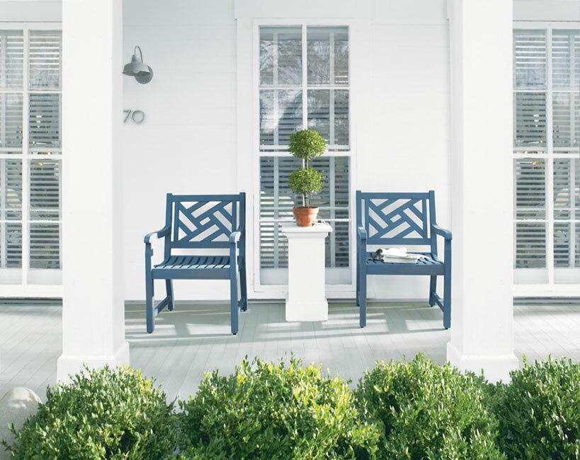 Two deep blue arbour chairs provide a sophisticated pop of colour against a white deck. Two deep blue arbour chairs provide a sophisticated pop of colour against a white deck.