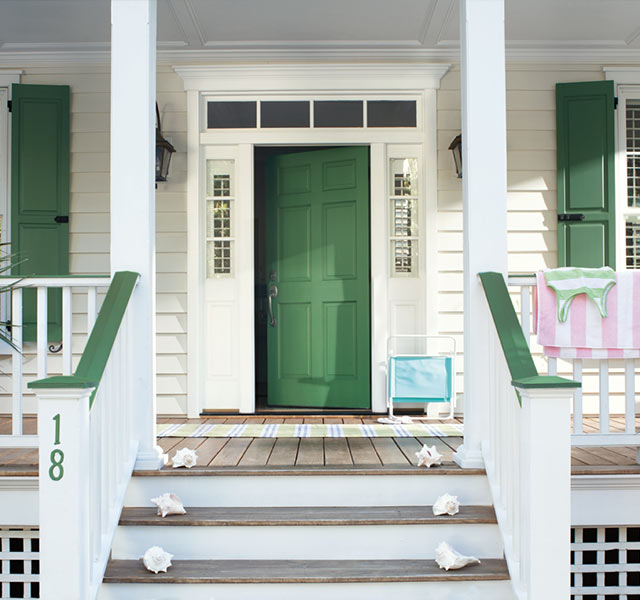Green front door with matching window shutters. Green front door with matching window shutters.