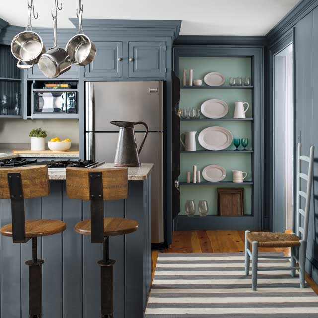A farmhouse kitchen using a blue, blue-green and green colour scheme creates an elegant look.