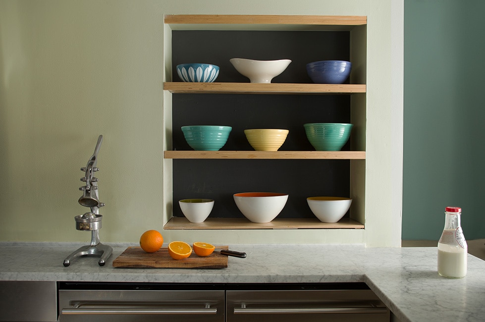 A kitchen with a yellow, yellow-green and green colour combination using muted hues.