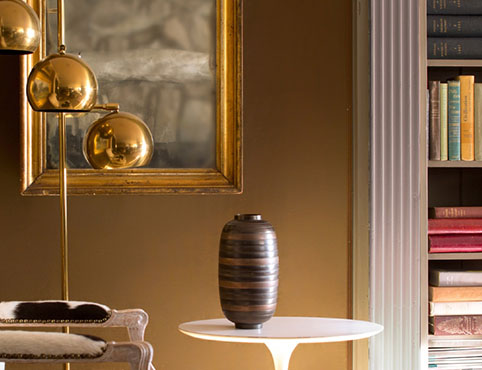 Warm, golden brown reading room with bookshelf Warm, golden brown reading room with bookshelf
