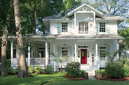 Traditional home with red door in Caliente AF-290, wrap-around porch and siding with White Diamond OC-61.