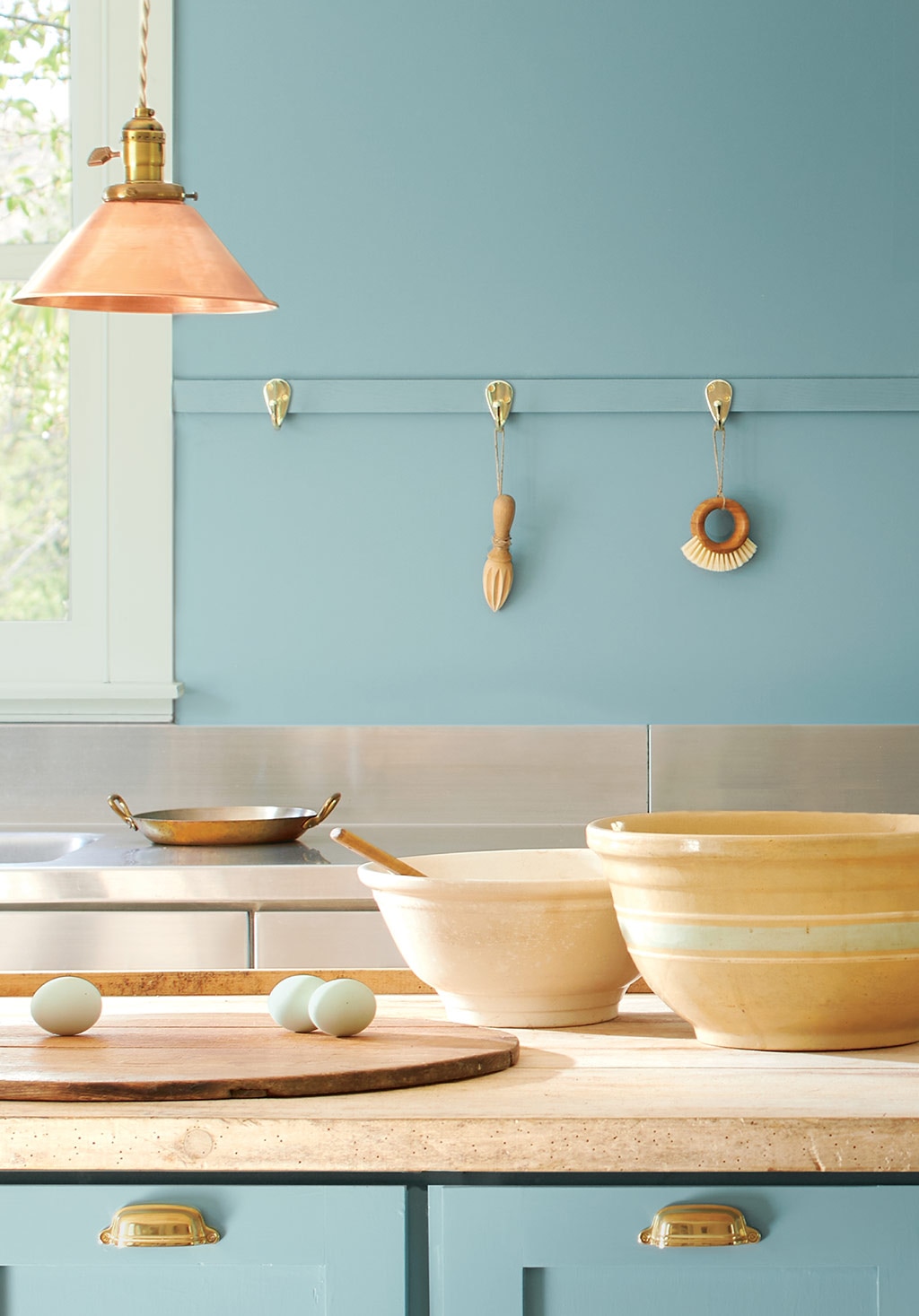 A kitchen with walls and cabinets painted with the Colour of the Year 2021, Aegean Teal 2136-40.