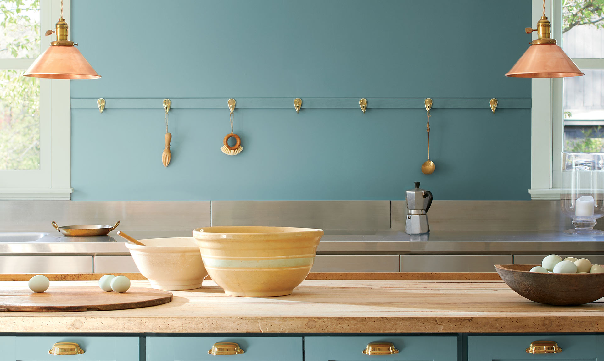 A kitchen with walls and cabinets painted with the Color of the Year 2021, Aegean Teal 2136-40.