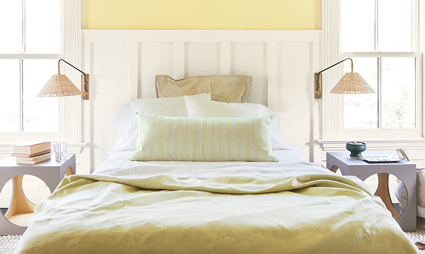 A bedroom in Beacon Hill Damask HC-2 with trim and wainscotting painted in Atrium White OC-145.