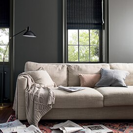 Charcoal gray-painted walls, trim and windows add depth to a cozy family room with beige couch. Charcoal gray-painted walls, trim and windows add depth to a cozy family room with beige couch.