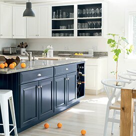 A bright, airy kitchen with blue island and white walls and cabinets. A bright, airy kitchen with blue island and white walls and cabinets.