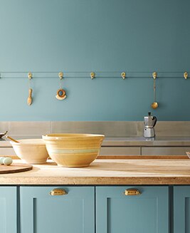 A kitchen with walls and cabinets painted with the Color of the Year 2021, Aegean Teal 2136-40