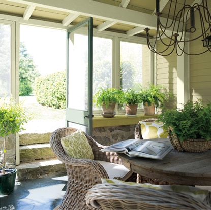 Refreshing greens and yellows flood an enclosed rustic deck. Refreshing greens and yellows flood an enclosed rustic deck.