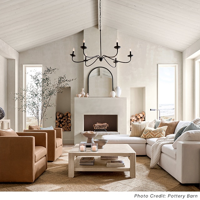An off-white living space with shiplap walls and neutral furniture.