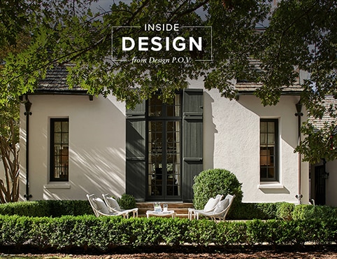 A sun-dappled home exterior painted in a creamy beige with deep sage green-painted doors and trim with an alfresco seating area. A sun-dappled home exterior painted in a creamy beige with deep sage green-painted doors and trim with an alfresco seating area.