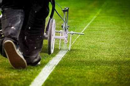 A field marking paint machine in use