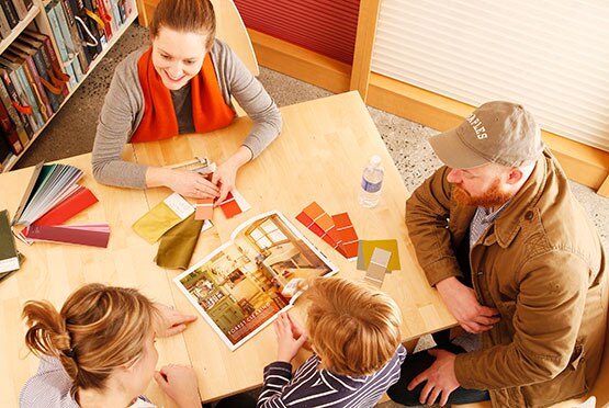 Customers discuss color options in a Benjamin Moore store