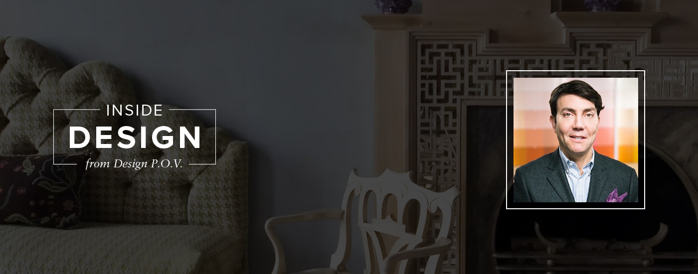 A living room with a herringbone-printed couch, wooden chair, and ornate fireplace, featuring a headshot of Eric Cohler.