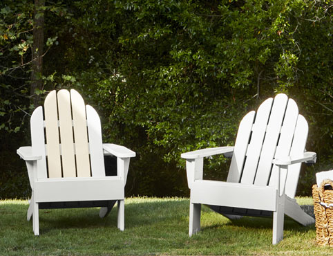 Wood Adirondack chairs painted in a white paint colour.