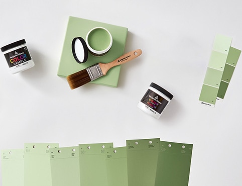 An open can of paint color sample and an array of color swatches.