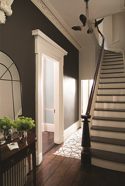 Hallway painted in deep brown paint color with eggshell finish