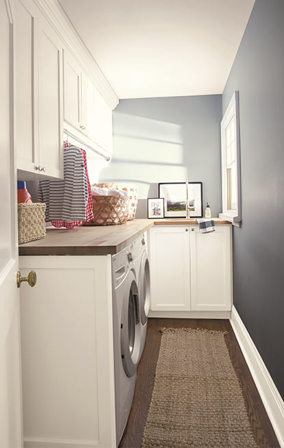 Laundry room walls painted in blue gray paint color with pearl finish